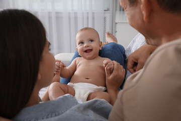 Happy family with their cute baby at home