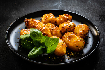 Gnocchi with in tomato sauce, parmesan and basil on wooden table
