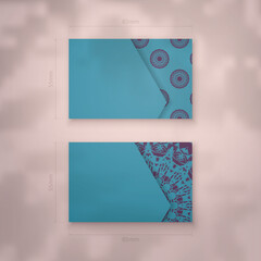 Presentable business card in turquoise color with Indian purple pattern for your personality.