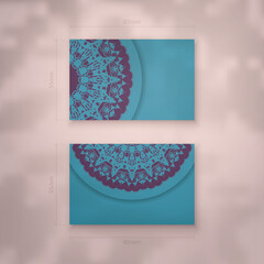 Presentable business card in turquoise color with Indian purple pattern for your contacts.