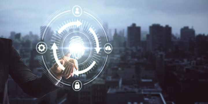 Close up of businessman hand pointing at abstract glowing fingerprint id scanning interface on blurry city background with mock up place. Biometrics and safety concept. Double exposure.