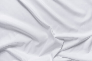Obraz premium Abstract white fabric texture background. Cloth soft wave. Creases of satin, silk, and cotton.