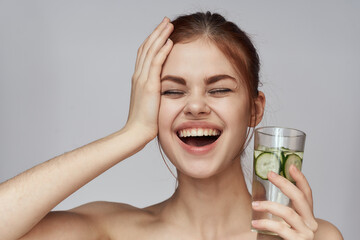 woman with cucumber drink health vitamins close-up