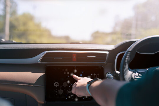 Male hand touching scrfuturistic vehicle and graphical user interface(GUI). intelligent car. connected car. Internet of Things.