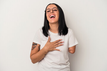 Young caucasian woman with one arm isolated on white background laughs out loudly keeping hand on...