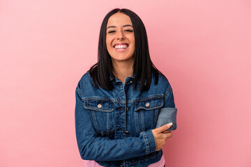 Young caucasian woman with one arm isolated on pink background laughing and having fun.
