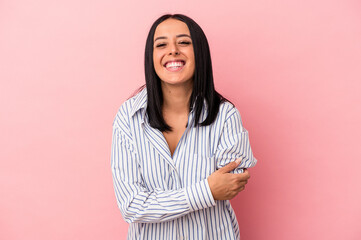 Young caucasian woman with one arm isolated on pink background laughing and having fun.