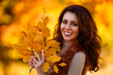 Naklejka na ściany i meble portrait of a beautiful woman in the woods in autumn season