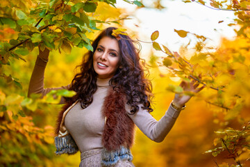 portrait of a beautiful woman in the woods in autumn season