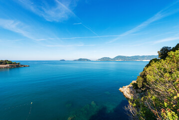 Gulf of La Spezia and beautiful bay with seascape in front of the Lerici town, Liguria, Italy, Europe. On horizon the small town of Porto Venere or Portovenere and the Tino and Palmaria island.