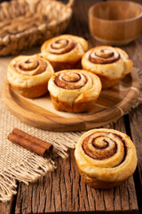 Cinnamon rolls on wooden background.