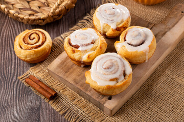 Cinnamon rolls on wooden background.
