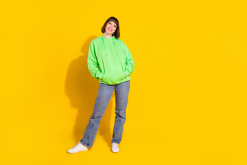 Fototapeta na wymiar Full length body size view of pretty confident cheerful girl posing wearing cozy clothes isolated over bright yellow color background