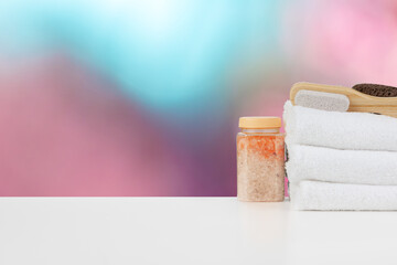 Various spa beauty threatment products and towels against blurred background