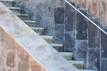 marble steps run along the wall with a metal rail