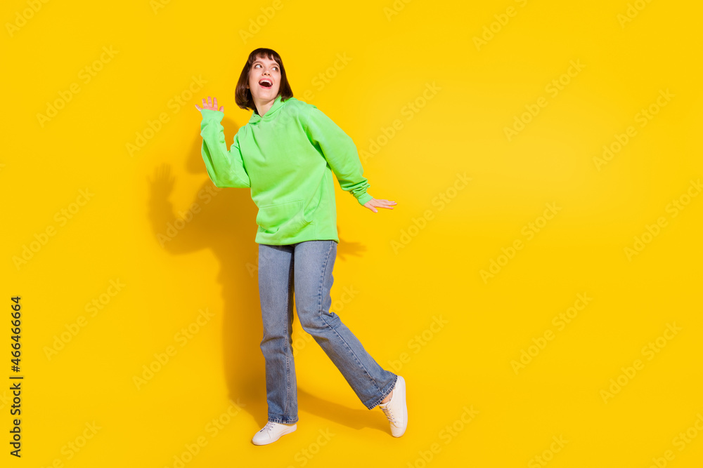 Poster Full length body size view of attractive cheerful girl dancing having fun copy space isolated over bright yellow color background