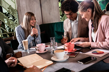 Group of business people having meeting in cafe.