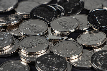 Silver coins background. Ukrainian 10 hryvnias coins. Money and finances. Ukrainian coins.
