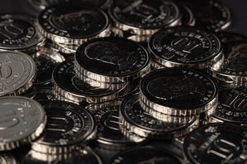 Silver coins background. Ukrainian 10 hryvnias coins. Money and finances. Ukrainian coins.