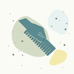 Hand holds the hair brush on multicolored background.