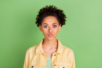 Fototapeta na wymiar Photo of cute millennial brunette lady blow kiss wear yellow shirt isolated on green color background