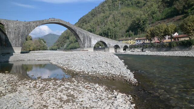 The river Serchio flows under the Ponte della Maddalena or del Diavolo, Borgo a Mozzano, Lucca, Italy