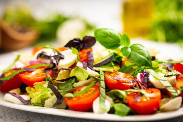 salad with tomato and basil leaves