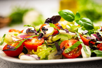 salad with tomato and basil leaves