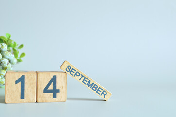 September 14, Calendar cover design with number cube with green fruit on blue background.