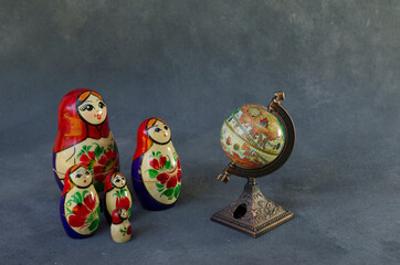 family of mamushkas, russian dolls in front of the planet earth