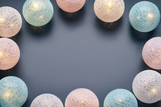 The concept of Christmas, New Year cards, congratulations. On a gray background, glowing balls, copy space.