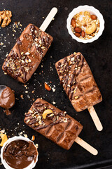 Chocolate ice cream popsicle with nut