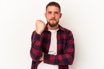 Young caucasian man with diastema isolated on white background showing fist to camera, aggressive...
