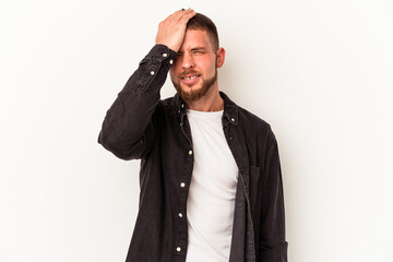Young caucasian man with diastema isolated on white background forgetting something, slapping forehead with palm and closing eyes.
