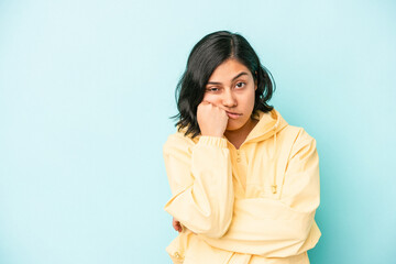 Young latin woman isolated on blue background who feels sad and pensive, looking at copy space.