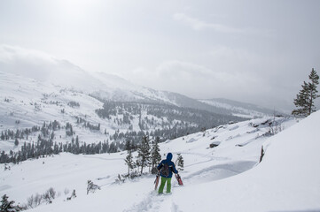 Fototapeta na wymiar skiing in the mountains, skier on the top of mountain