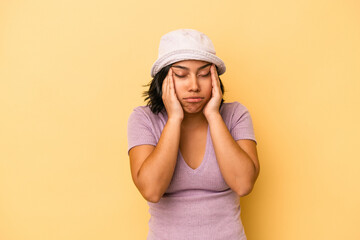 Naklejka premium Young latin woman isolated on yellow background touching temples and having headache.