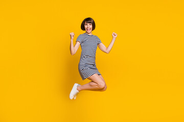 Full body profile photo of funny young lady jump wear blue dress sneakers isolated on yellow background