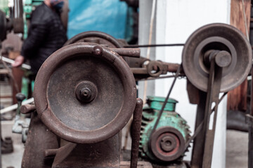 Close-up and selective focus to the circular lever of an old industrial lathe.