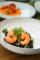 Black risotto with roasted shrimps	