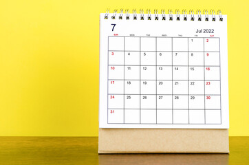 The July 2022 desk calendar with yellow background.