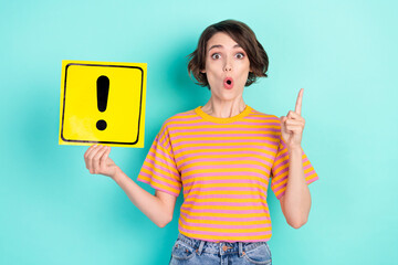 Photo of funny impressed young woman dressed striped t-shirt holding exclamation point card...