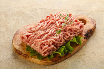 Raw minced pork meat over board