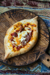 Traditional Georgian pie with smoked sausage and cheese