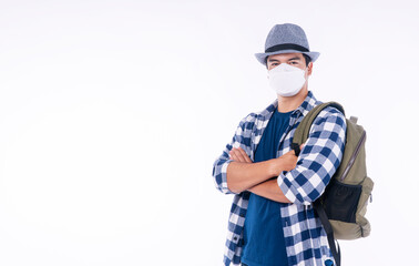 New normal lifestyle travel vacation concept. Traveler adventure handsome young man wear casual shirt, hat and protective mask safety with backpack while standing over isolated background