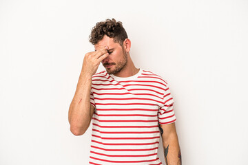 Young caucasian man isolated on white background having a head ache, touching front of the face.