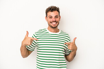 Fototapeta premium Young caucasian man isolated on white background points down with fingers, positive feeling.