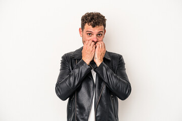 Young caucasian man isolated on white background biting fingernails, nervous and very anxious.