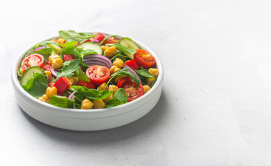 Vegetarian chickpea beans salad prepared with tomatoes and cucumber with copy space