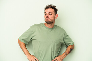 Fototapeta premium Young caucasian man isolated on green background dreaming of achieving goals and purposes